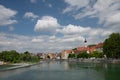 A small historic town in Bavaria, Landsberg am Lech against a blue sky with clouds. The river Lech flows past the town, in which