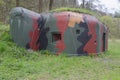Small historic WWII bunker in camo colours