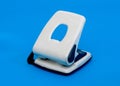 Small hole puncher on blue Royalty Free Stock Photo