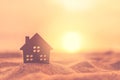 Small home model on sunset beach sand texture background Royalty Free Stock Photo