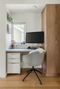 A small home office with a comfy chair, a big computer monitor Royalty Free Stock Photo