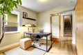 Small home office interior with hardwood floor. View of staircase.