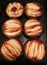 Small homemade apple pies freshly baked each in its mold Royalty Free Stock Photo