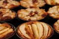 Small homemade apple pies freshly baked each in its mold Royalty Free Stock Photo