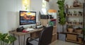 Small homeoffice for photographer with plants decor and Bromo Mt picture on the destop wall paper Royalty Free Stock Photo