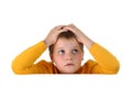 Small hopeless boy holding head with both hands Royalty Free Stock Photo