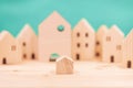 Small house in the big city concept. little model wooden home in the wood village Royalty Free Stock Photo