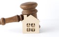 Small house concept with and gavel on white wooden background Royalty Free Stock Photo