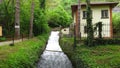 A small house cottage nearby a river in the forest. Mountain water nature plants trees vegetation. Royalty Free Stock Photo