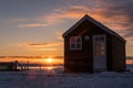 Small house in countryside in winter sunrise