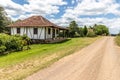 Small house in enxaimel style, dirty road with flowers and plants around