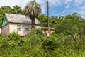 Small house in enxaimel style, dirty road with flowers and plants around