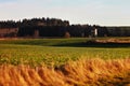 A small house in a field at sunset. Royalty Free Stock Photo