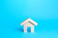 Small house figurine on a blue background. Minimalism. Affordable housing. Rent of real estate. Construction industry. Utility Royalty Free Stock Photo