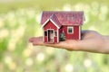 Small house in hand sun green nature Royalty Free Stock Photo