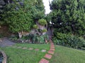 Small house with landscaped backyard and blooming plants Royalty Free Stock Photo