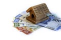 Small house made of clay on mexican bills, savings,  in white background Royalty Free Stock Photo