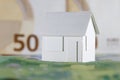 Small house model and European Union currency Royalty Free Stock Photo