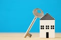 small house model with key over wooden floor. selective focus Royalty Free Stock Photo