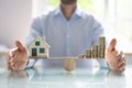 Businessperson Protecting House Model And Stacked Coins Royalty Free Stock Photo