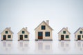 Small House Models Arranged In Row Over Table Royalty Free Stock Photo
