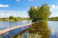 Small house one the island. Landscape with bridge to the house on lake. Old wooden fisherman`s and hunter`s house on the island. Royalty Free Stock Photo