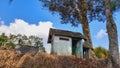 a small house painted white under two large trees on a white background with a blue sky Royalty Free Stock Photo