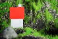 Small house with a red roof on a background of stones and moss. place for text Royalty Free Stock Photo