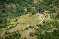 Small house red roof in mountains with car path Royalty Free Stock Photo