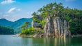 A small house on top of a rock in the middle of korean lake Royalty Free Stock Photo