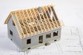 Small house under construction on electrical drawings, concept of building home Royalty Free Stock Photo