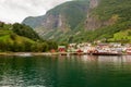 Small houses of the commune on the fjord, photographed from a sightseeing cruise ferry departing in summer from Flam, Norway Royalty Free Stock Photo