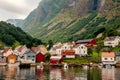 Small houses of the commune on the fjord, photographed from a sightseeing cruise ferry departing in summer from Flam, Norway Royalty Free Stock Photo