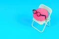 Small Human Brain Adorned with Glasses Set on a Chair on Blue
