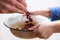 Small hungry child gets food donate help a volunteer, with bowl full of beans