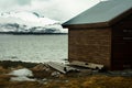 A small hunting lodge in the norwegian mountains and with mountain summits in the background Royalty Free Stock Photo