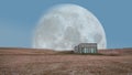 Small hut and beautiful huge surreal moon during the sunset in Iceland,