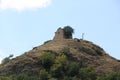 Small hut made of stone on top of a mountain with a blue sky in the background Royalty Free Stock Photo
