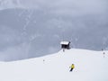 Small hut and skiers Royalty Free Stock Photo