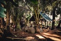 Small hut in a tropical forest with wooden cages for the lifestock. Local village on Nusa Penida, Bali