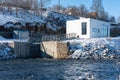 A small hydroelectric power station is located on the river in winter Royalty Free Stock Photo
