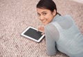 So small I can take it any where. An attractive young woman surfing the net on her digital tablet. Royalty Free Stock Photo