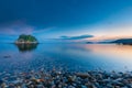 Small idyllic green isle at stoney coast in italy Royalty Free Stock Photo