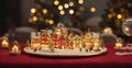 A small illuminated model village toy is displayed with candles on a bokeh Christmas table. quaint, Royalty Free Stock Photo