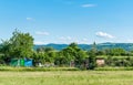 Small improvised refugee camp with houses and protective fence in the nature