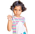 Small indian asian girl holding pencil