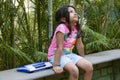 Small Indian girl upset looking upwards with her toy laptop by her side, Pune