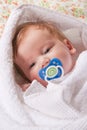 Small infant with dummy and dreamstime logo on it Royalty Free Stock Photo