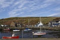 The small Inner harbour with its various Vessels tied up at Low Tide in the small Scottish Fishing Village of Gourdon Royalty Free Stock Photo