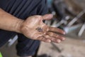 A small iron ball by a mechanic's hand. hands are stained with oil. Bicycle bearing The hand of a motorcycle mechanic Royalty Free Stock Photo